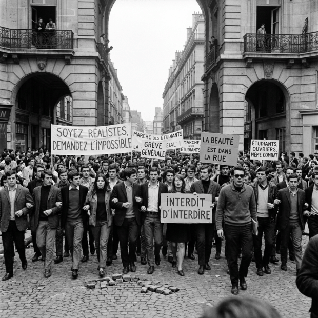 Students marching through Paris with protest signs during May 1968